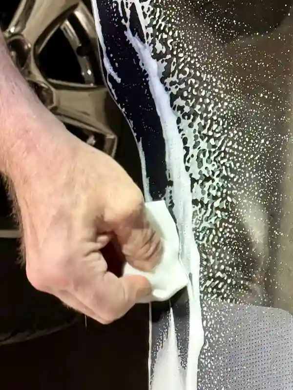 Cleaning windshield bonding surface with BETACLEAN™ GC-800 and Easy-Go Cleaning Sponge before adhesive application at 123 Glass Company in Omaha