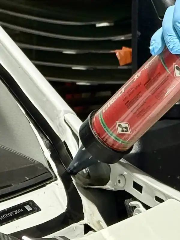 Applying BETASEAL™ urethane adhesive to pinch weld during windshield replacement at 123 Glass Company in Omaha