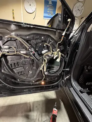 Disassembly of door panel for window regulator motor replacement at 123 Glass Company in Omaha