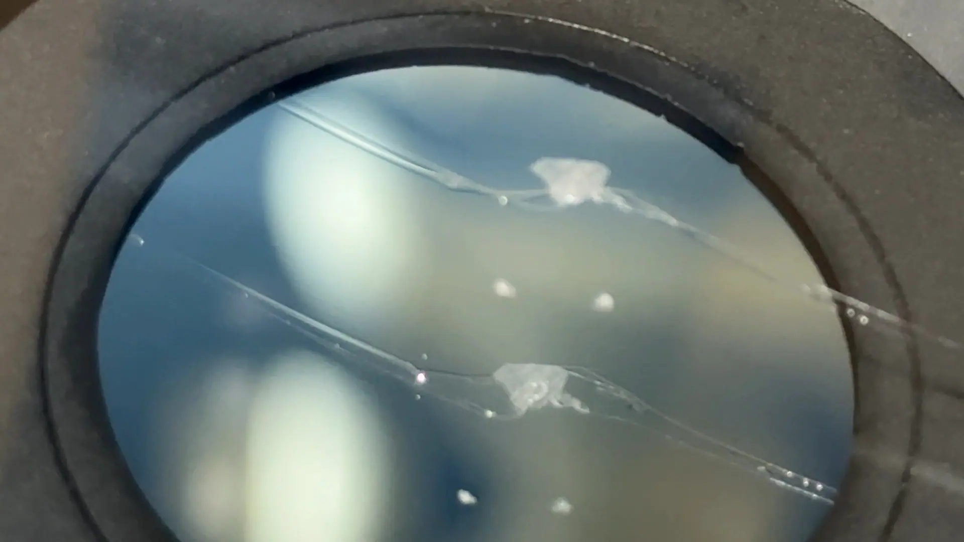 Completed windshield crack repair with only faint blemishes remaining.