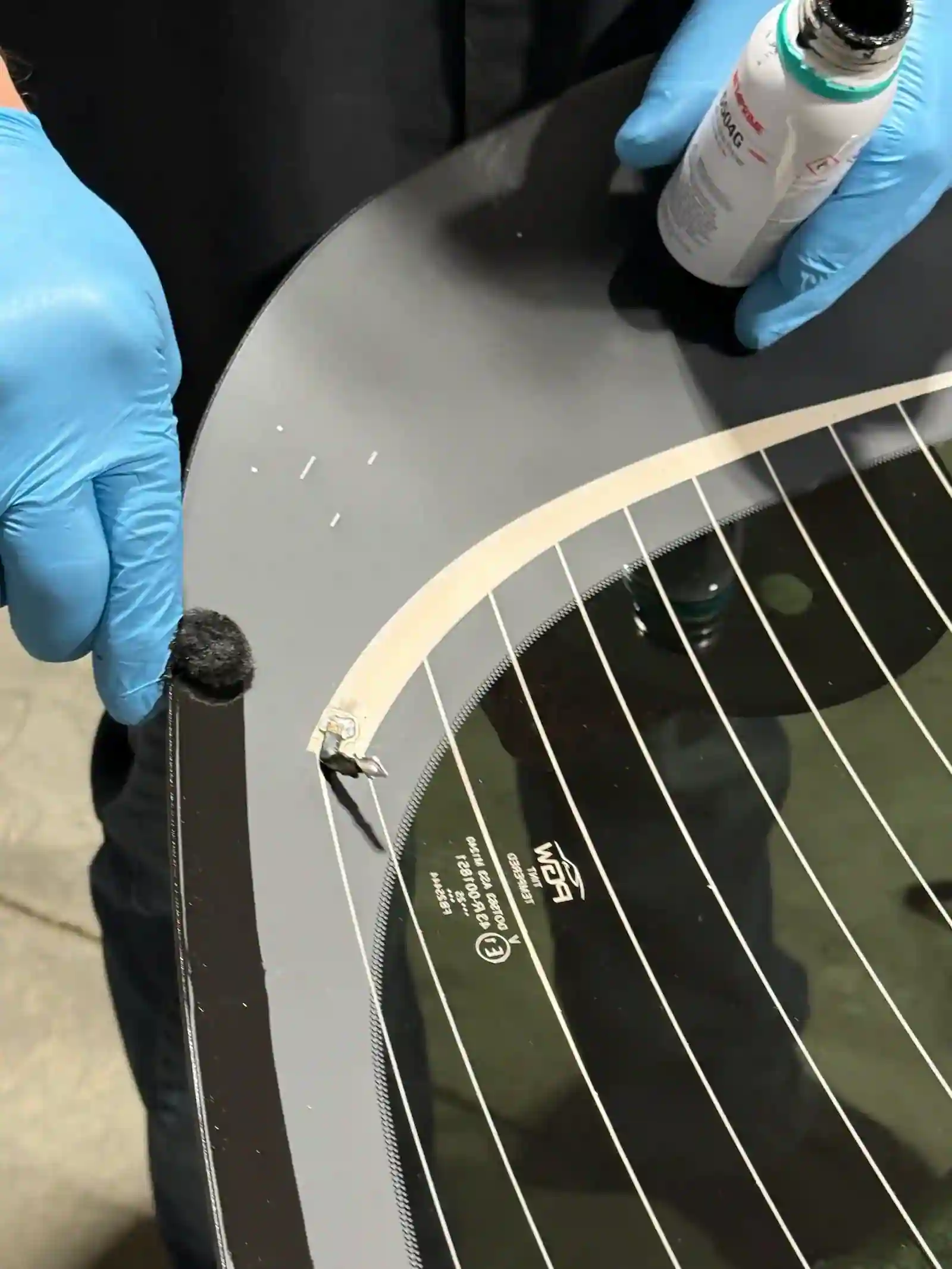 Applying automotive primer during glass installation at 123 Glass Company in Omaha