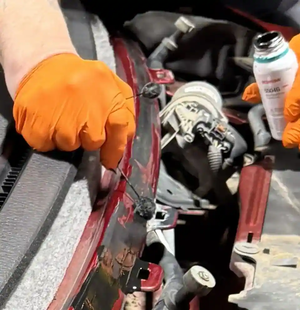 Applying pinchweld primer during professional windshield replacement in Omaha at 123 Glass Company