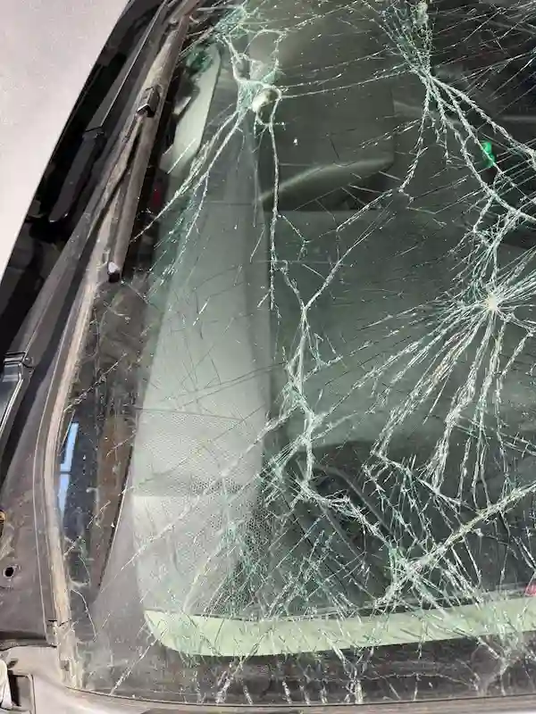 Lower windshield view of a Subaru Impreza showing the extent of hood-strike damage before windshield replacement at 123 Glass Company in Omaha.
