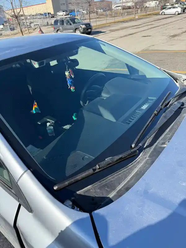 Close-up of the new windshield installed on a Subaru Impreza after a hood strike destroyed the original glass — 123 Glass Company Omaha.