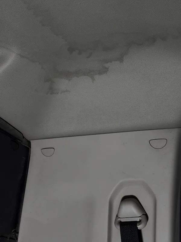 Second headliner water stain on a pickup truck — moisture had traveled through the roof structure before surfacing here.