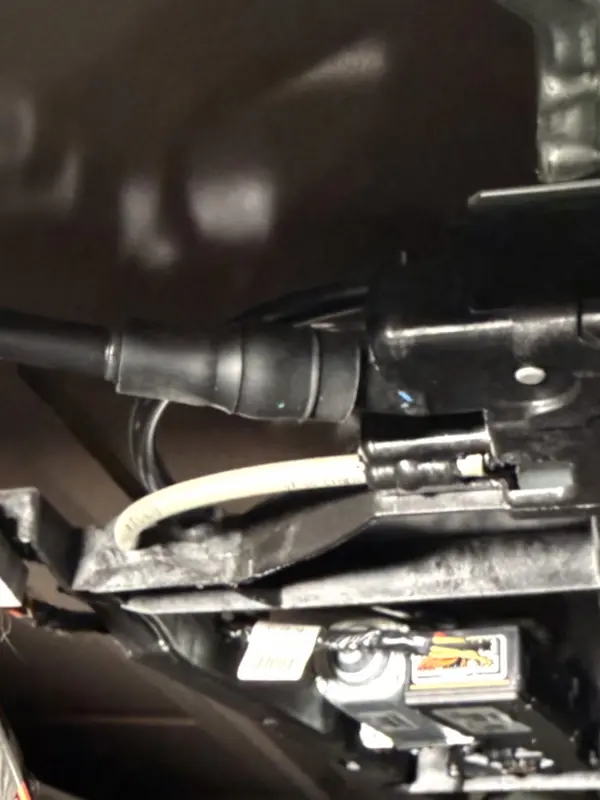 Sunroof drain fitting visible above the headliner with drain hose still connected — before inspection.