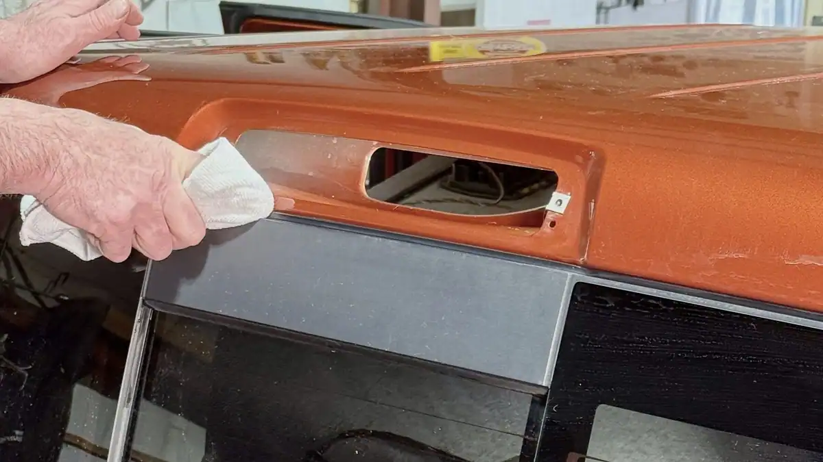Rear taillight assembly removed on a pickup truck, mounting surface being cleaned before gasket repair at 123 Glass Company in Omaha.