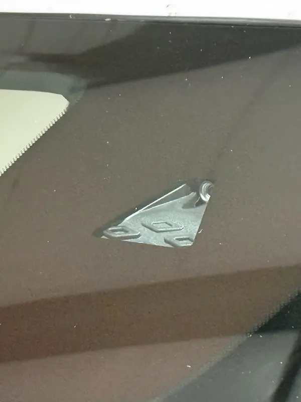 Close up image of a windshield mounted ADAS camera through a trapezoid shaped cutout in the third visor