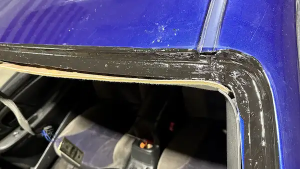 Driver side upper windshield corner primed and ready for glass installation on a 2004 Chevy Monte Carlo.