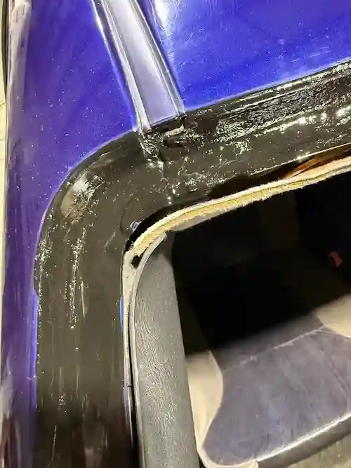 Passenger side upper windshield corner primed and ready for glass installation on a 2004 Chevy Monte Carlo.