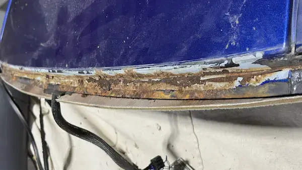 Corroded top rail pinch weld on a 2004 Chevy Monte Carlo — rust running the full bonding surface after windshield removal.