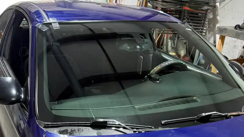 Completed windshield replacement on a 2004 Chevy Monte Carlo — new glass installed and fully bonded at 123 Glass Company in Omaha.