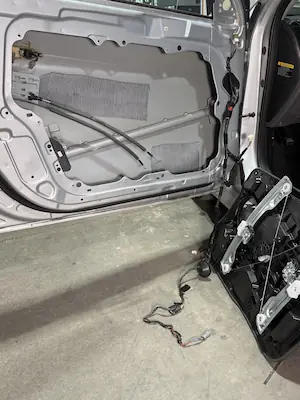 Window regulator removed and ready for installation at 123 Glass Company in Omaha