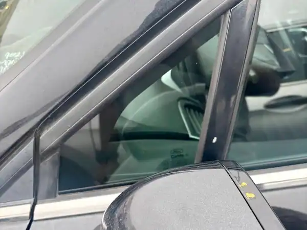 Front driver side vent window fixed on a black car