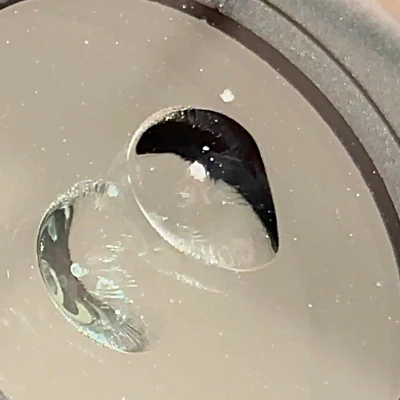 Bullseye windshield chip — clean cone-shaped circular break in the outer layer of glass.