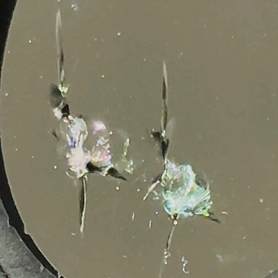 Double star windshield chip — two intersecting star chips from multiple impact points.