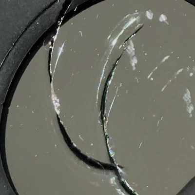Ring crack on windshield — large circular crack from a round object impact.